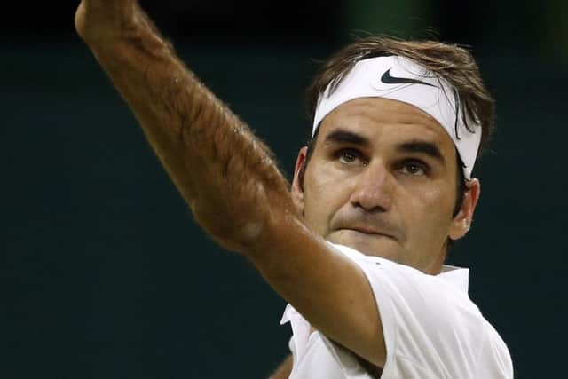 Roger Federer serves to Dan Evans during his 6-4, 6-2, 6-2 triumph on Centre Court last night. Picture: AP