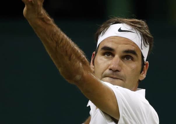 Roger Federer serves to Dan Evans during his 6-4, 6-2, 6-2 triumph on Centre Court last night. Picture: AP