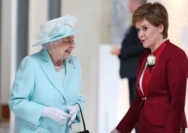 Nicola Sturgeon shares a joke with the Queen. Picture: PA