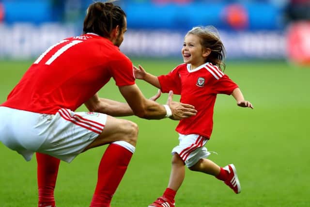 The joy on the face of Gareth Bales daughter Alba Violet as she runs to her dad after Fridays victory reflects the mood of a nation. Picture: Getty Images