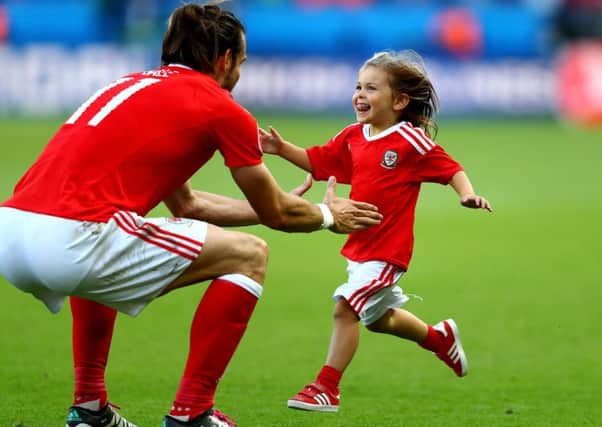 The joy on the face of Gareth Bales daughter Alba Violet as she runs to her dad after Fridays victory reflects the mood of a nation. Picture: Getty Images