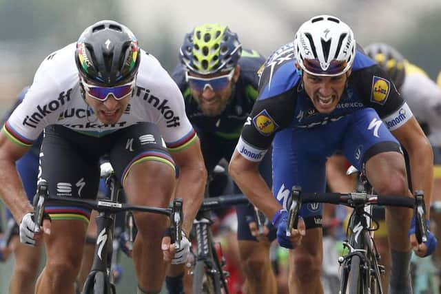 Peter Sagan, left, powers over the line ahead of Julian Alaphilippe, right, and Alejandro Valverde. Picture: AP