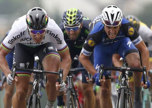 Peter Sagan, left, powers over the line ahead of Julian Alaphilippe, right, and Alejandro Valverde. Picture: AP