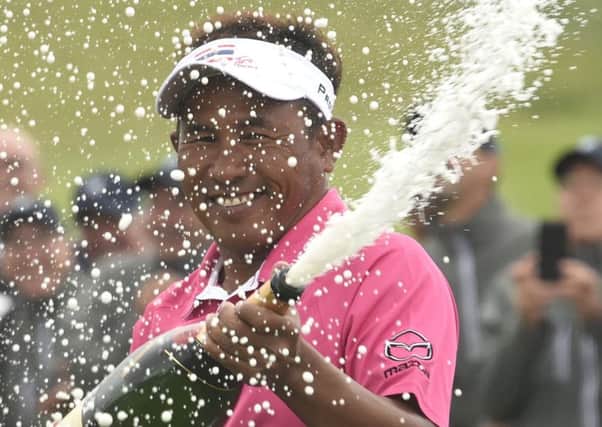 A delighted Thongchai Jaidee cracks open the bubbly after winning in Paris by four strokes. Picture: AFP/Getty Images