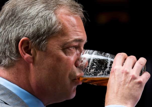 Exit stage right: Ukips Nigel Farage with his trademark man-of-the-people pint. He  has achieved his destructive aim. Picture: Getty