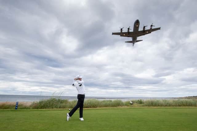 Jack Doherty tees off at the 16th hole on his way to victory as an RAF Hercules flies overhead. Picture: Kenny Smith