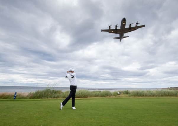 Jack Doherty tees off at the 16th hole on his way to victory as an RAF Hercules flies overhead. Picture: Kenny Smith