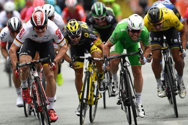 Mark Cavendish, in green, inches past Andre Greipel, in white, to win the third stage of the Tour de France. Lionel Bonaventure/AFP/Getty Images