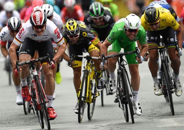 Mark Cavendish, in green, inches past Andre Greipel, in white, to win the third stage of the Tour de France. Lionel Bonaventure/AFP/Getty Images