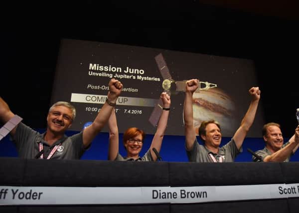 Nasa project chiefs celebrate at a press conference after the Juno spacecraft was successfully placed into Jupiter's orbit. Picture: Getty Images