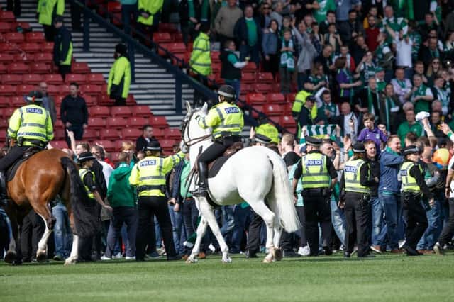 Police had to separate fans on the field after the full time whistle. Picture: Robert Perry