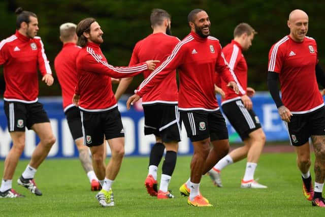 Wales captain Ashley Williams, centre, shares a joke with team-mates during training ahead of their European semi-final against Portugal. Picture: Stu Forster/Getty Images