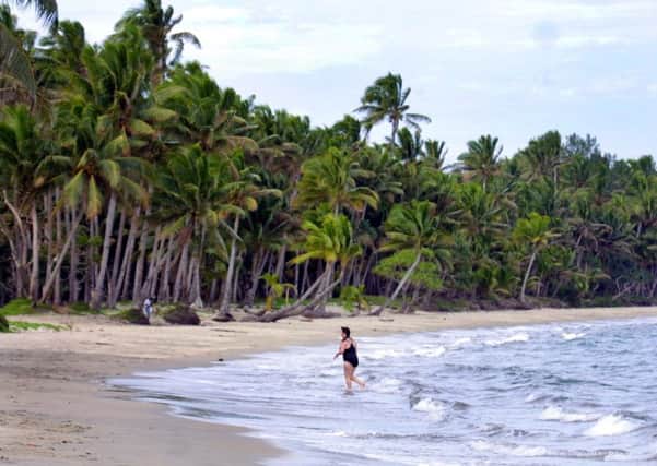 A tourist leaves the water after swimming at a beach near Suva, Fiji. Picture: AP