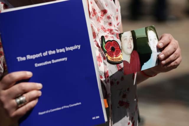 Sarah O'Connor holds up a photo of her brother Sergeant Bob O'Connor  who died in Iraq. Picture: PA