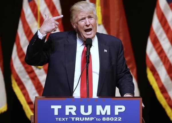 Republican Presidential candidate Donald Trump comments about his hair while speaking at a rally in Raleigh, N.C., Tuesday, July 5, 2016. (AP Photo/Gerry Broome)