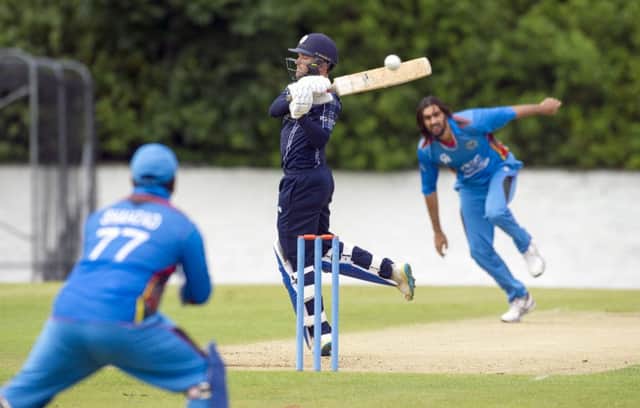 Craig Wallace fails to connect with a delivery from Shapoor Zadran  at the Grange yesterday. Picture: Donald MacLeod
