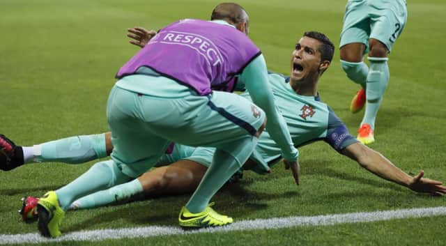 Ronaldo is jubilant after heading Portugal ahead in the 50th minute last night. Picture: Frank Augstein/AP