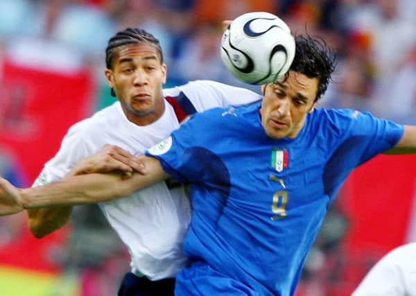 Onyewu, left, battling with Luca Toni at the 2006 World Cup. Picture: AFP/Getty
