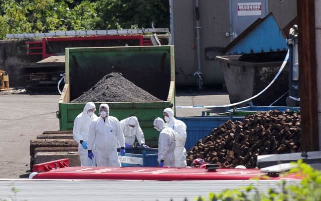 Forensic officers gather evidence at Hawkeswood Metal Recycling in Birmingham. Picture: SWNS