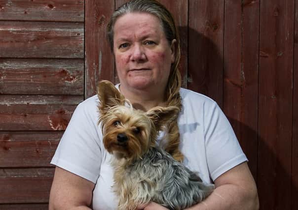 Helen Holland at home with one of her Yorkshire Terriers. Picture: John Devlin