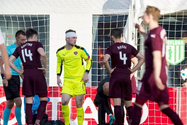 Jack Hamilton gets to his feet after being patched up following a clash of heads in Tallinn on Wednesday. Picture: SNS