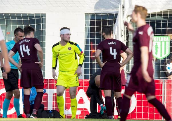 Jack Hamilton gets to his feet after being patched up following a clash of heads in Tallinn on Wednesday. Picture: SNS