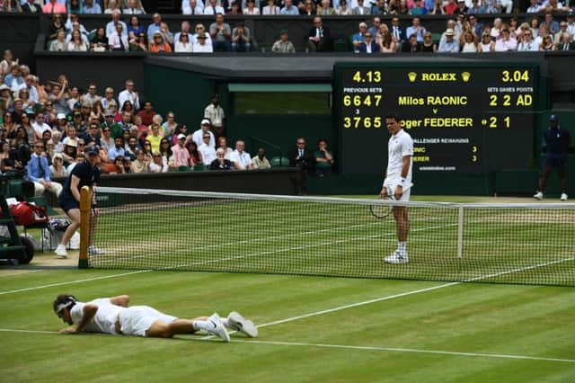 Roger Federer lies on court after falling while trying to return to Milos Raonic during their semi-final encounter. Picture: AFP/Getty