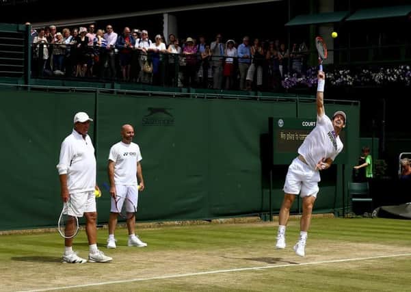 Coaches Ivan Lendl and Jamie Delgado watch as Andy Murray goes through his practice routines.
Photograph:Getty
