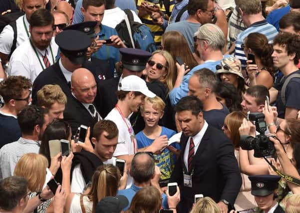 Signing autographs while cameras flash around him is all part of the game for Murray. Photograph: AFP/Getty