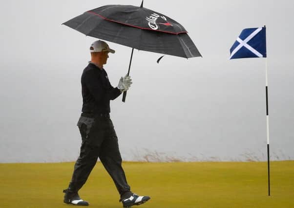 Leader Alex Noren walks on the 18th green at Castle Stuart yesterday. Picture: Getty.