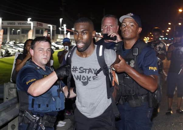 Police arrest activist DeRay McKesson during a protest along Airline Highway in front of the Baton Rouge Police Department headquarters. Picture: Max Becherer