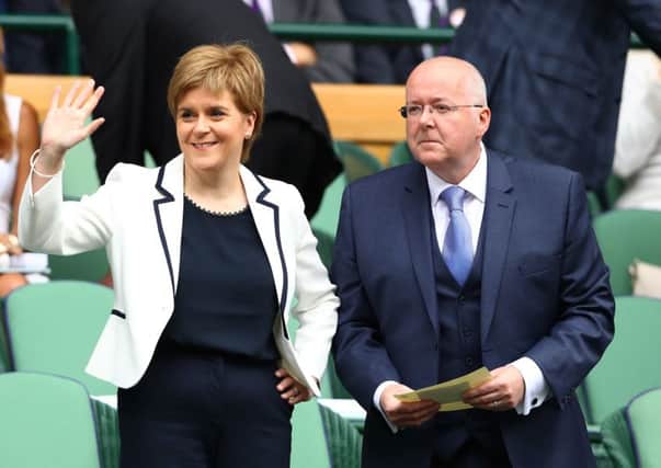 Nicola Sturgeon and Peter Murrell look on to Centre Court  (Photo by Julian Finney/Getty Images).