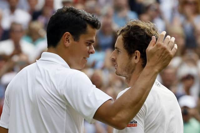 Andy Murray speaks with Milos Raonic after beating him in the men's singles final. Picture: AP