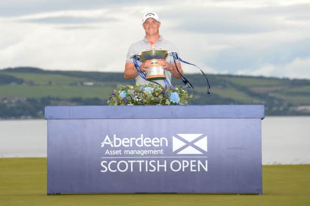 Swedens Alex Noren holds the trophy at Castle Stuart after claiming a one-shot victory in the Scottish Open with a 14-under-par total. Picture: SNS