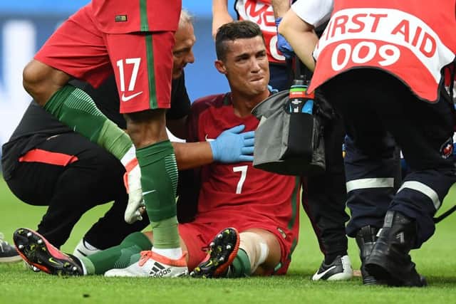 A stretcher comes on for the tearful Cristiano Ronaldo, who sustained a knee injury when he was tackled by Dimitri Payet. Picture: AFP/Getty