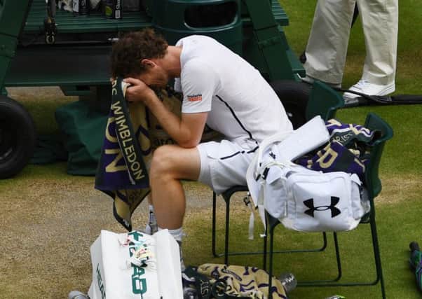 Andy Murray buried his head in his towel after winning his second Wimbledon title. Picture: Getty