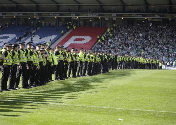 Police are still looking for fans involved in violent clashes after the Cup Final. Picture: Neil Hanna