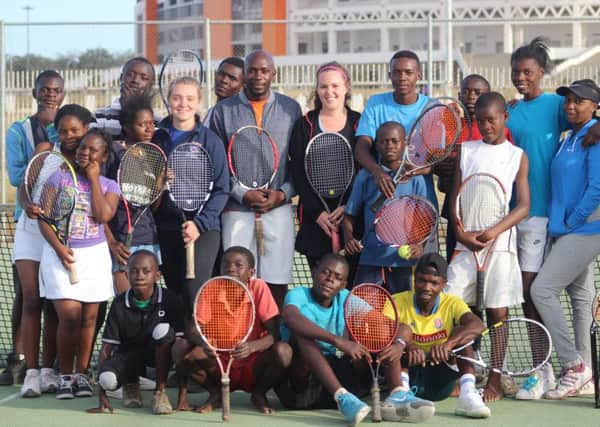 Regi Monroe, president of St Andrews University Tennis Club, is pictured with young players at Olymoic Youth Development Centre in Lusaka. PIC contributed.