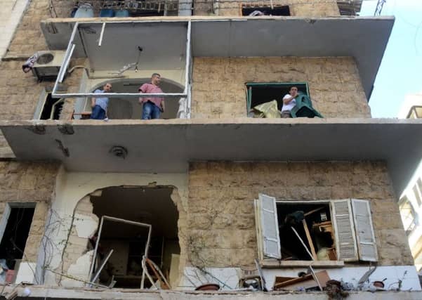 Syrians look at the damage in a street in the Syrian city of Aleppo.
Photo: Getty Images