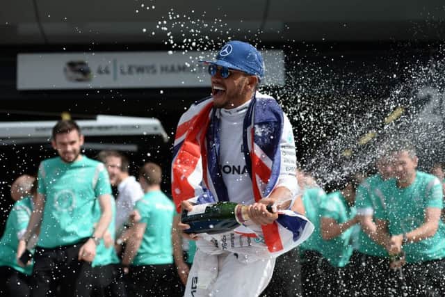 Lewis Hamilton celebrates victory at Silverstone which puts him just a point behind Nico Rosberg. Picture: AFP/Getty