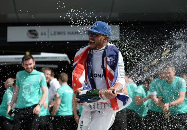 Lewis Hamilton celebrates victory at Silverstone which puts him just a point behind Nico Rosberg. Picture: AFP/Getty