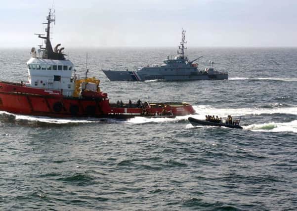 Two Turkish men found guilty of smuggling cocaine on the ocean-going tug MV Hamal (left) which was intercepted last year by the frigate HMS Somerset and Border Force cutter Valiant (right) about 100 miles east of Aberdeenshire. Picture: NCA/PA Wire