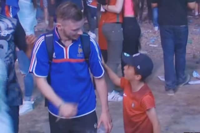 The young Portugal fan consoles the French supporter. Picture: YouTube/BBC