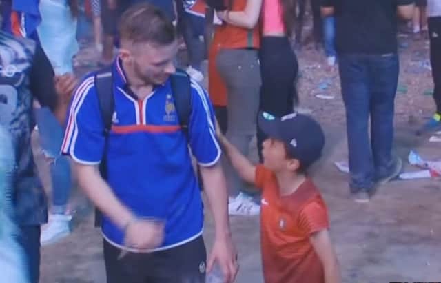 The young Portugal fan consoles the French supporter. Picture: YouTube/BBC