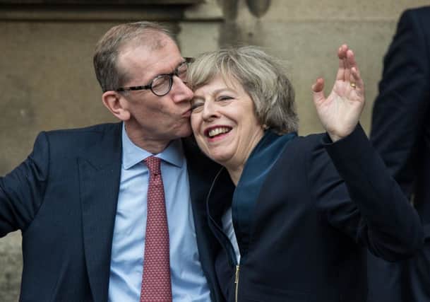 Theresa May is congratulated on her Conservative Party leadership win by her husband Philip. Picture: AFP/Getty