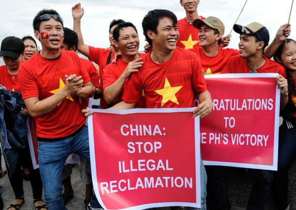 Protesters celebrate winning the case, filed in 2013 after China took control of a reef about 140 miles from the Philippines coast. Picture: Getty