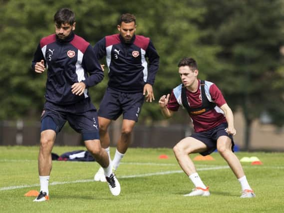 Hearts captain Alim Ozturk, left, leads Faycal Rherras,centre, and Liam Smith in training ahead of tomorrow's clash with Birkirkara. Picture: Alan Rennie/SNS Group