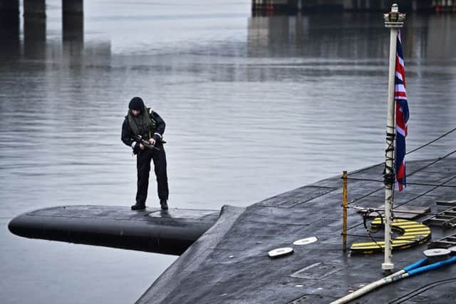 Royal Navy security personnel stand guard on HMS Vigilant, one of the UK's fleet of four submarines carrying the Trident nuclear missile system. Picture: Getty