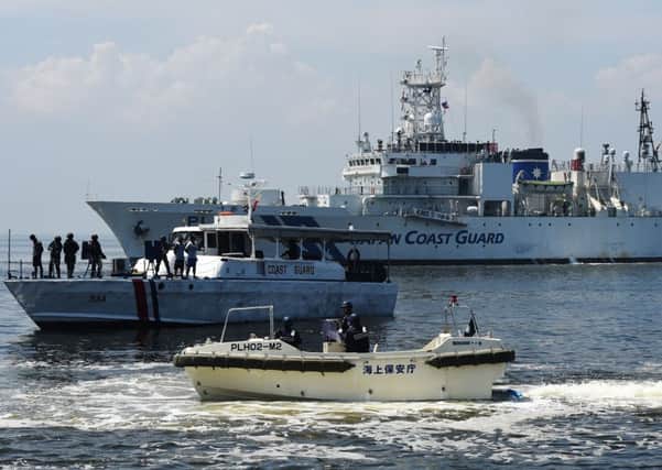 A Philippines Coast Guard boat on a joint anti-piracy exercise alongside a Japanese Coast Guard vessel in the waters off Manila Bay yesterday. Picture: Getty