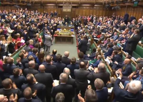 The SNP MPs can be seen seated on the right and not clapping in the House of Commons. Picture: PA